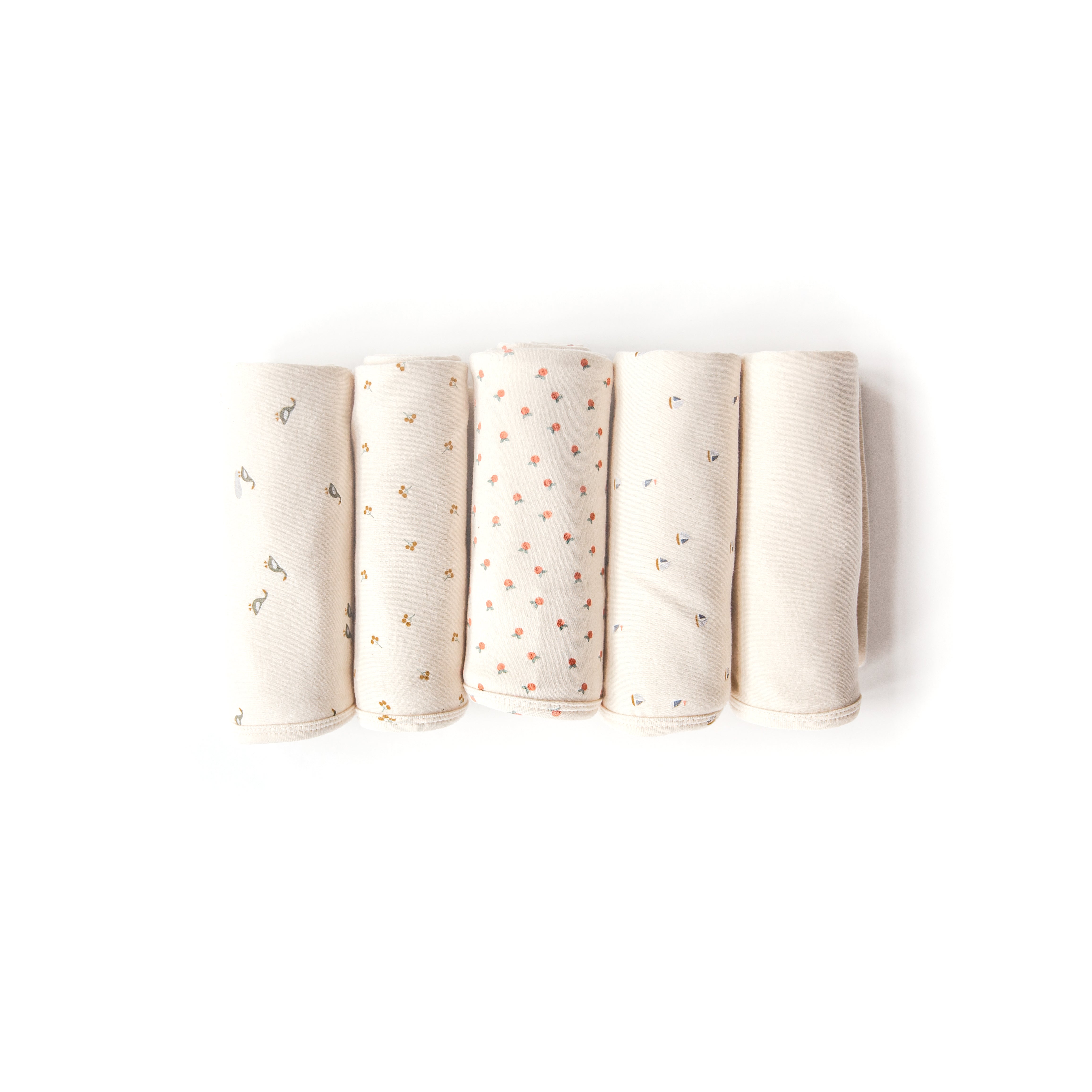 Oolie organic baby blankets in five different graphic prints, gently rolled on a white background.