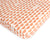 An Oolie organic cotton crib sheet with the red hills print, a natural color with a series of repeating red semicircles.