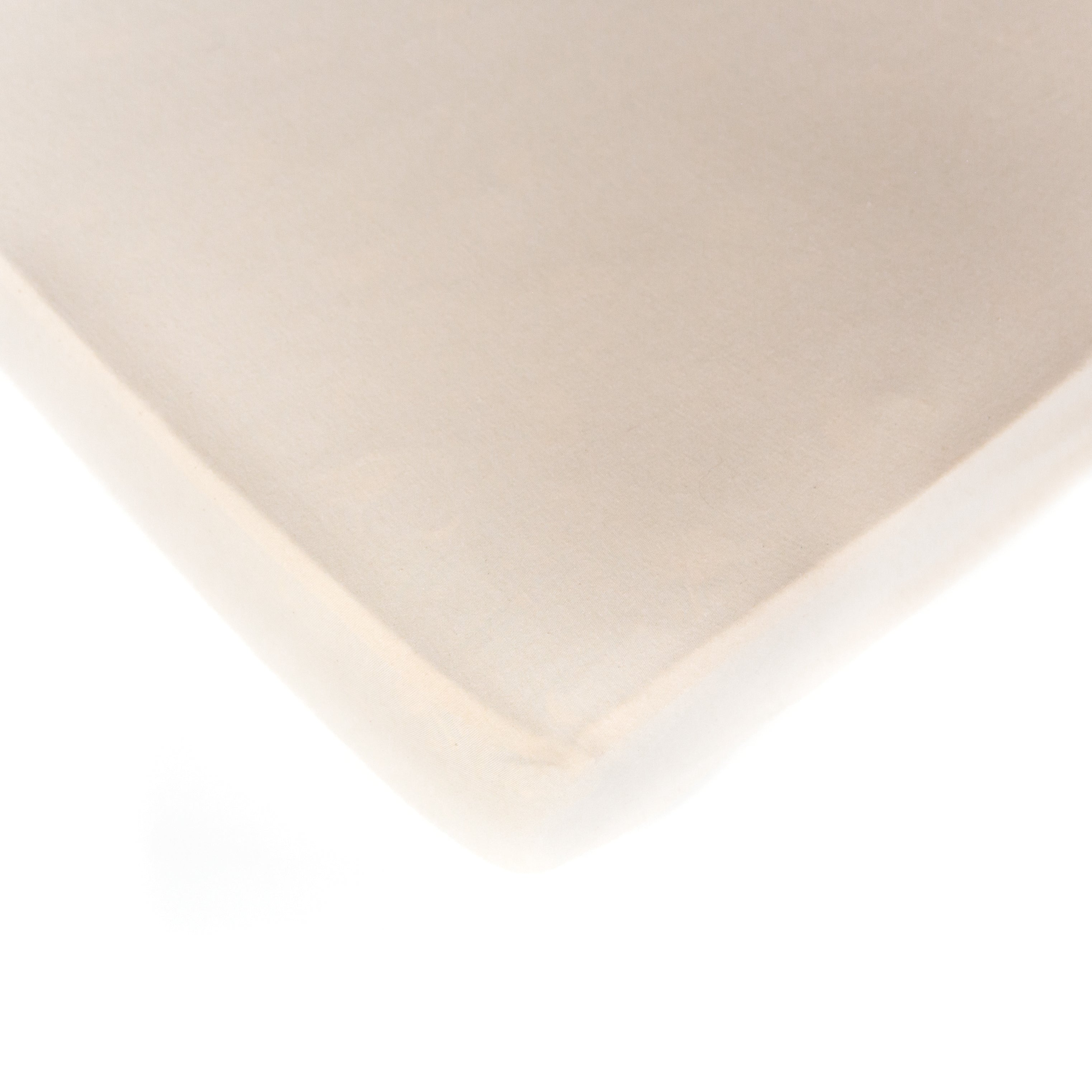 A natural, interlock jersey, Oolie organic cotton crib sheet, unprinted, revealing its natural, undyed, unbleached color.