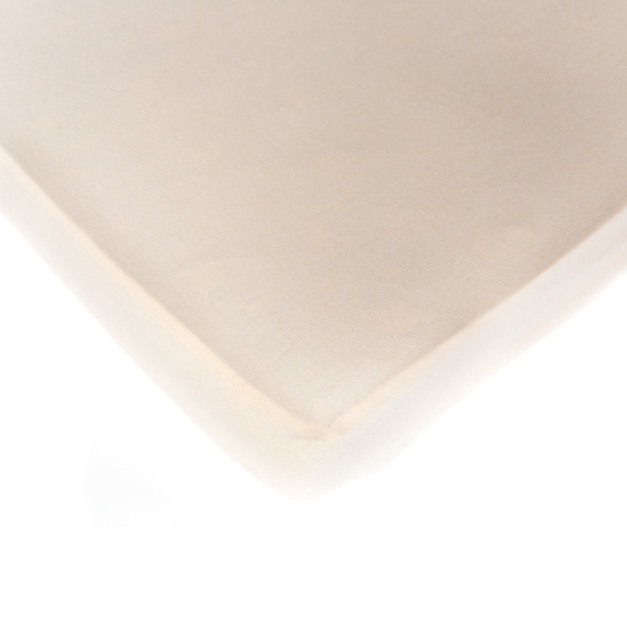 A natural, interlock jersey, Oolie organic cotton crib sheet, unprinted, revealing its natural, undyed, unbleached color.
