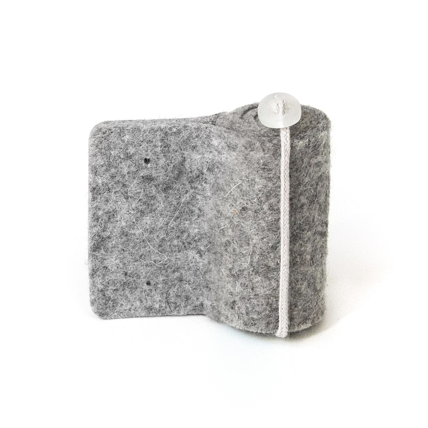A gray version of the Oolie Shoosh door silencer and safety bumper, shown on a white background.