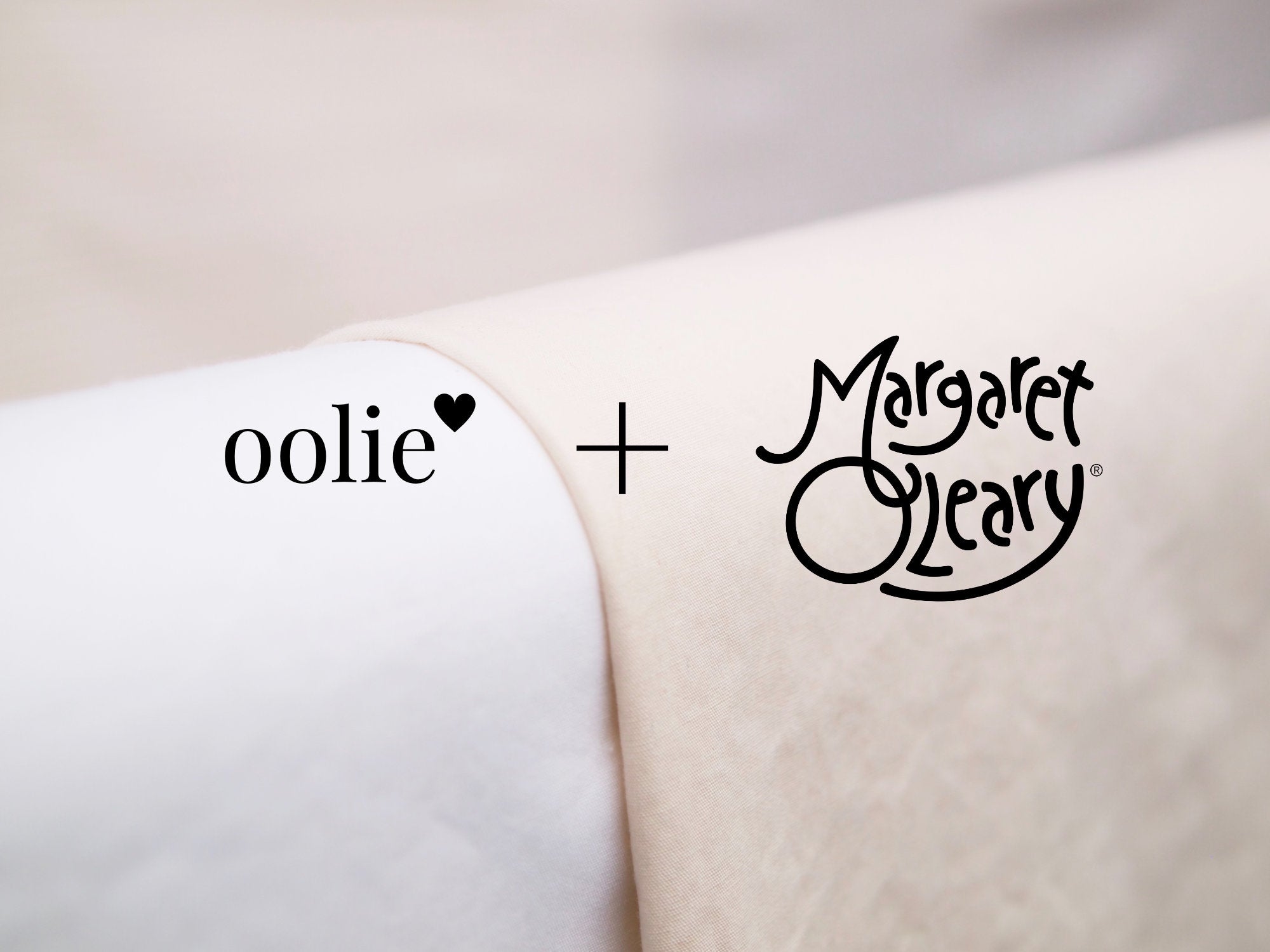 Oolie + Margaret O’Leary logos with light, organic, soft cotton sheets the background