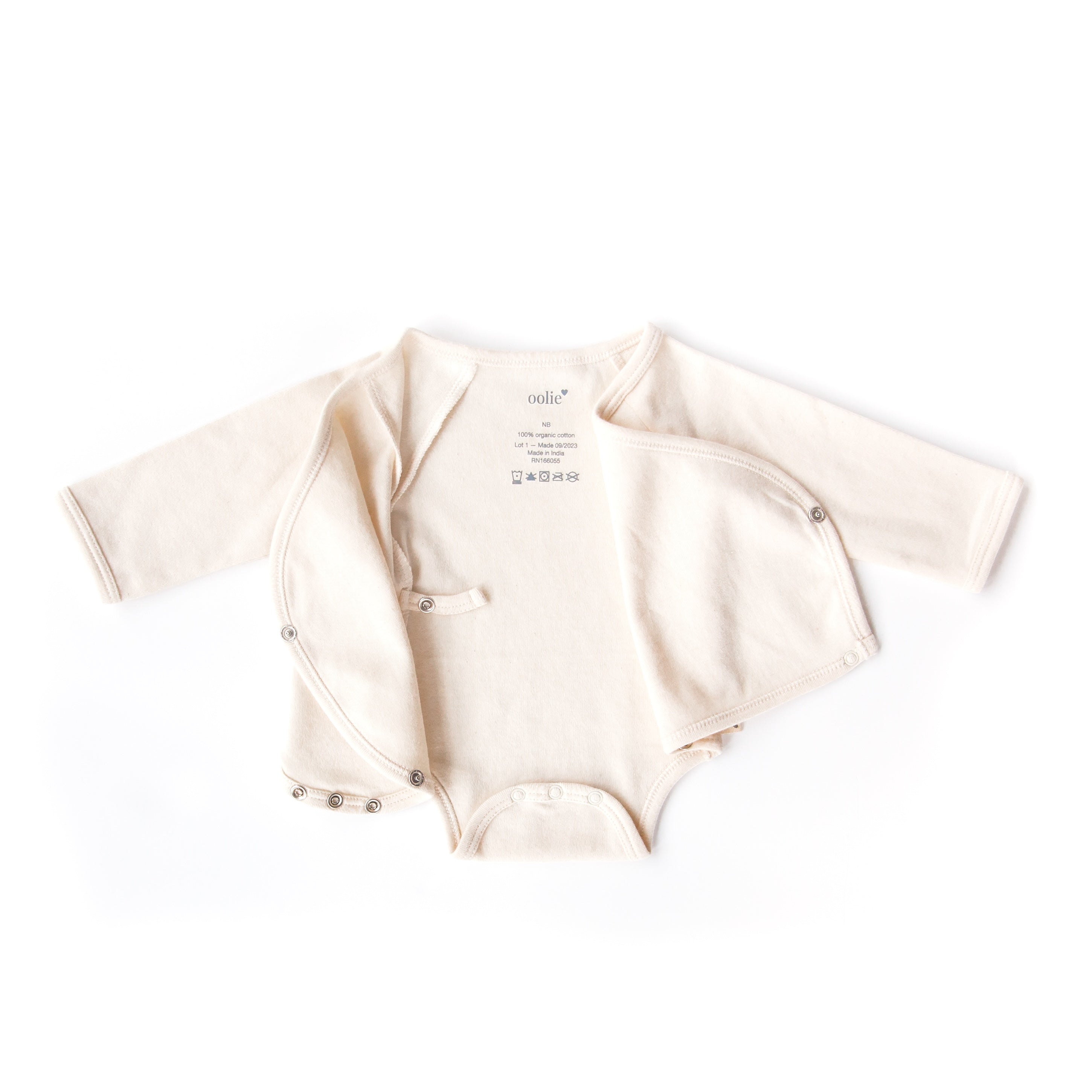 A natural color, Oolie organic cotton onesie, laid flat on a white background, fully unsnapped and with both left and right kimono-style flaps folded open to illustrate the shape of the garment.