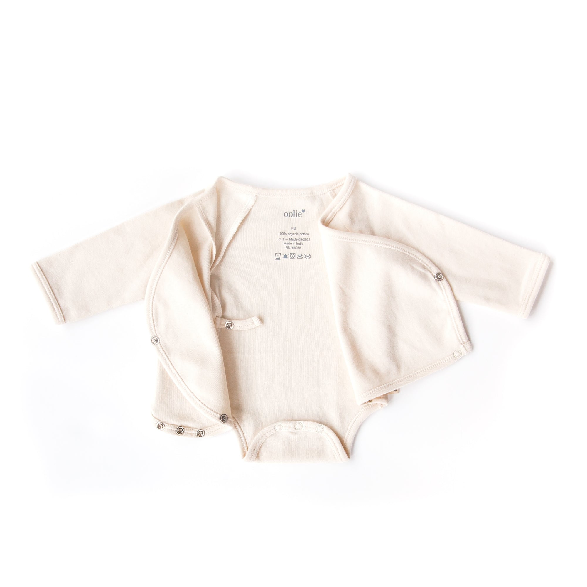 A natural color, Oolie organic cotton baby bodysuit, laid flat on a white background, fully unsnapped and with both left and right kimono-style flaps folded open to illustrate the shape of the garment.